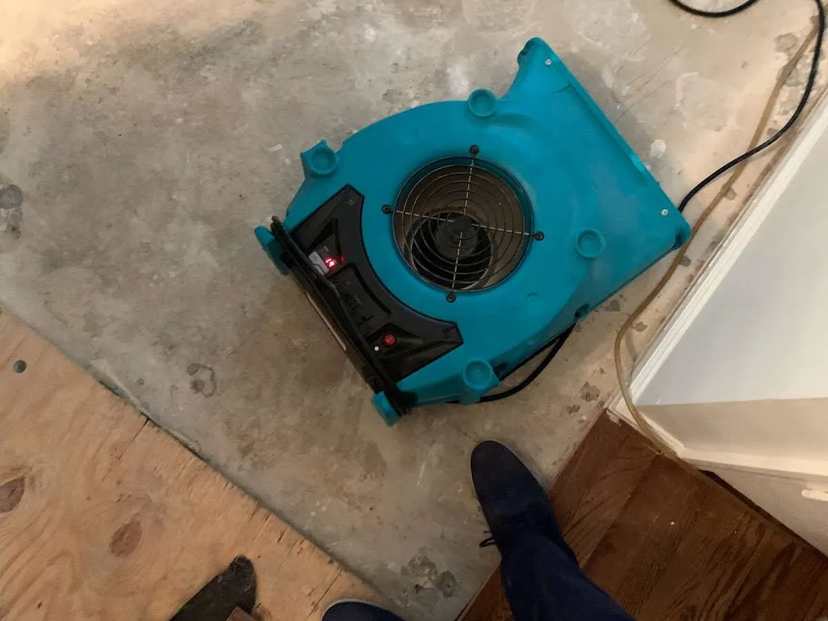 Air mover drying subfloor during Commercial Water Damage Restoration in Jamestown